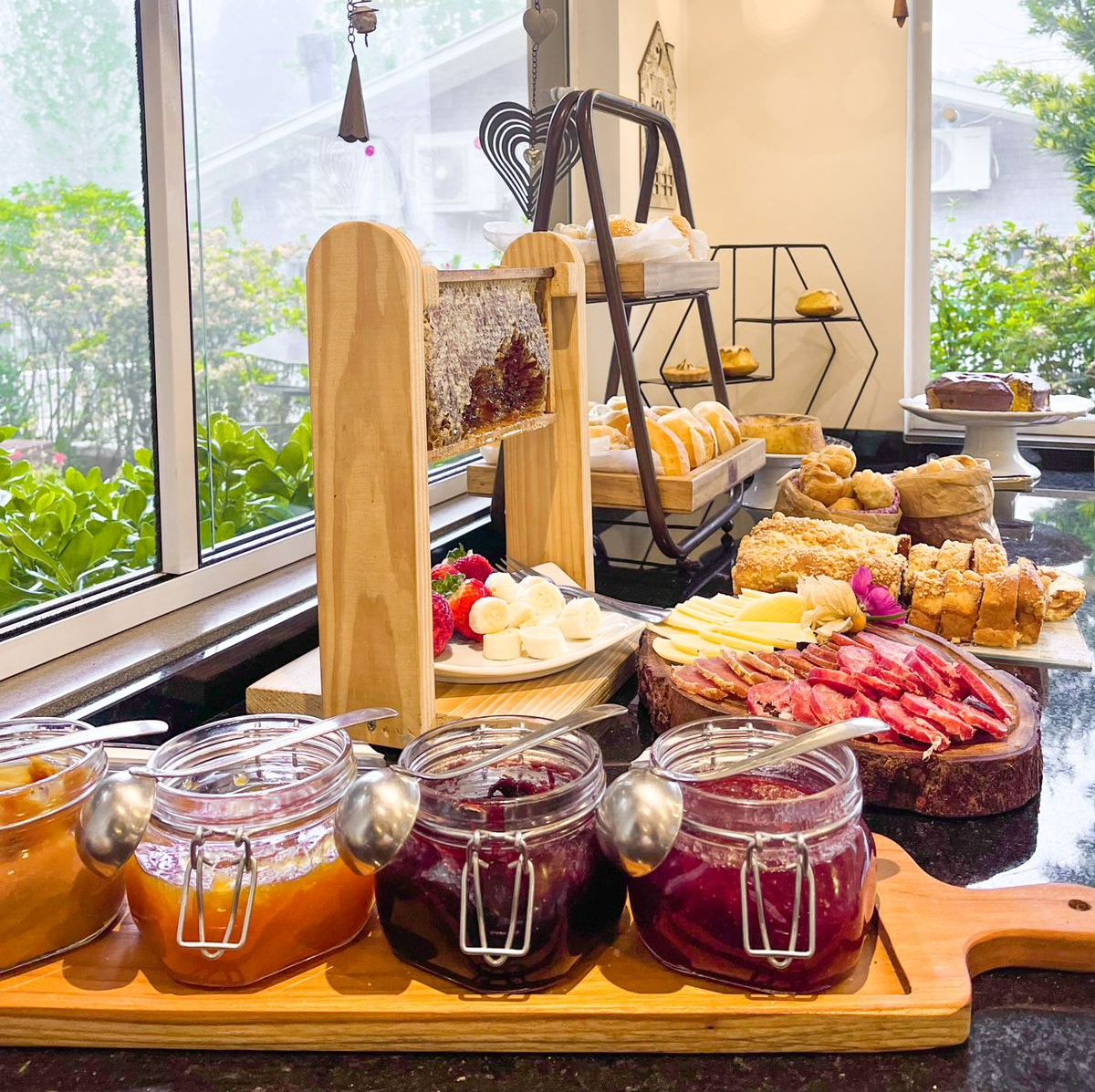 Uma mesa com potes de geléia e uma bandeja de comida.