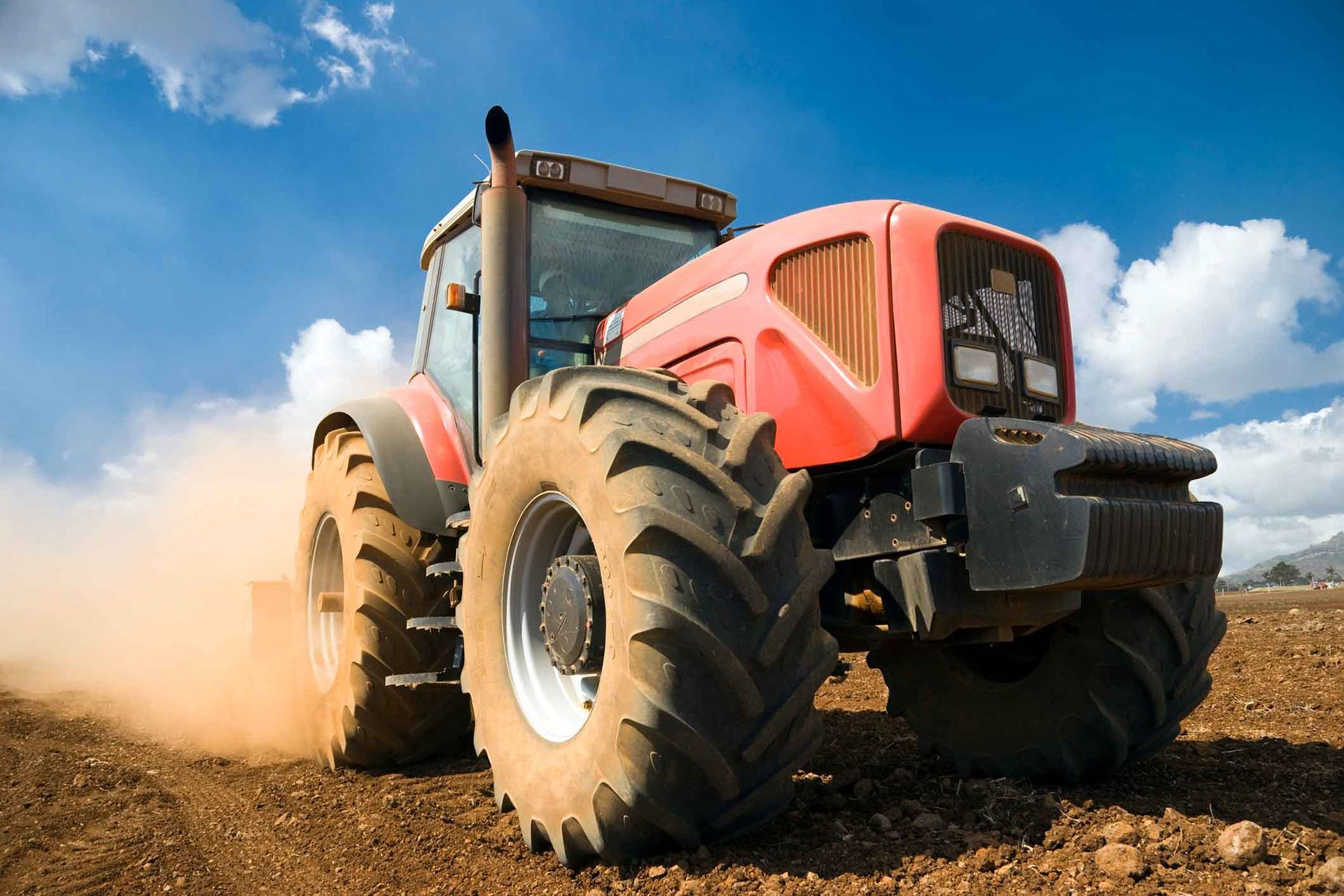 A Red Tractor Is Driving Through A Dirt Field – Delacombe, VIC - Transport Tyres