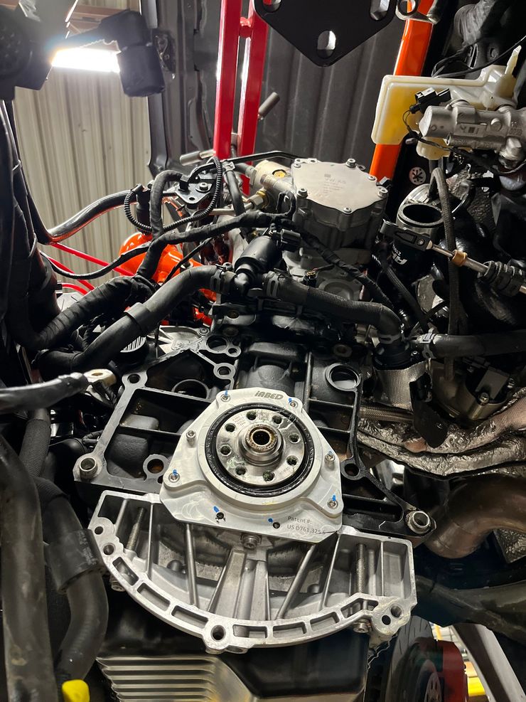 Engine block, partially disassembled, viewed from the front, in a garage. Various wires and components are visible. | A2B Euro Car Repair