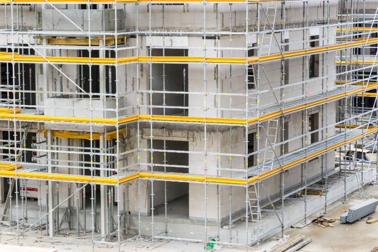 A Large Building is Being Built With Scaffolding Around It — RM Scaffolding Solutions in Evans Head, NSW