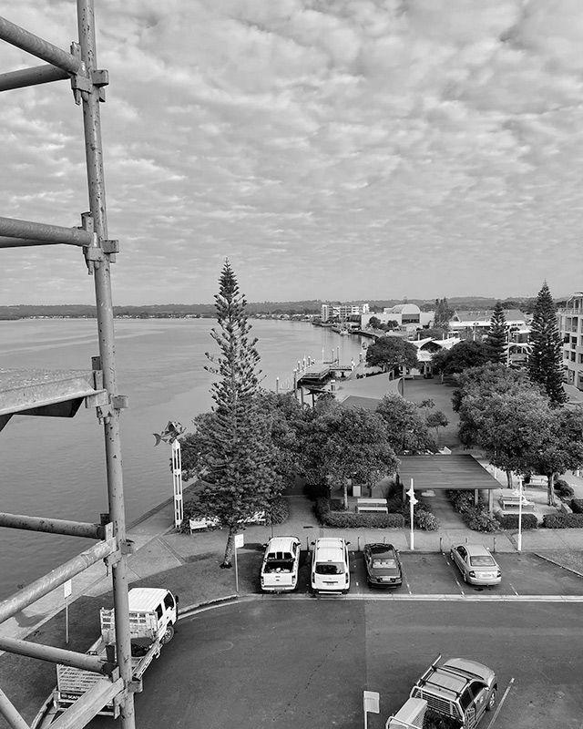 A Black and White Photo of a Parking Lot Next to a Body of Water — RM Scaffolding Solutions in Ballina, NSW