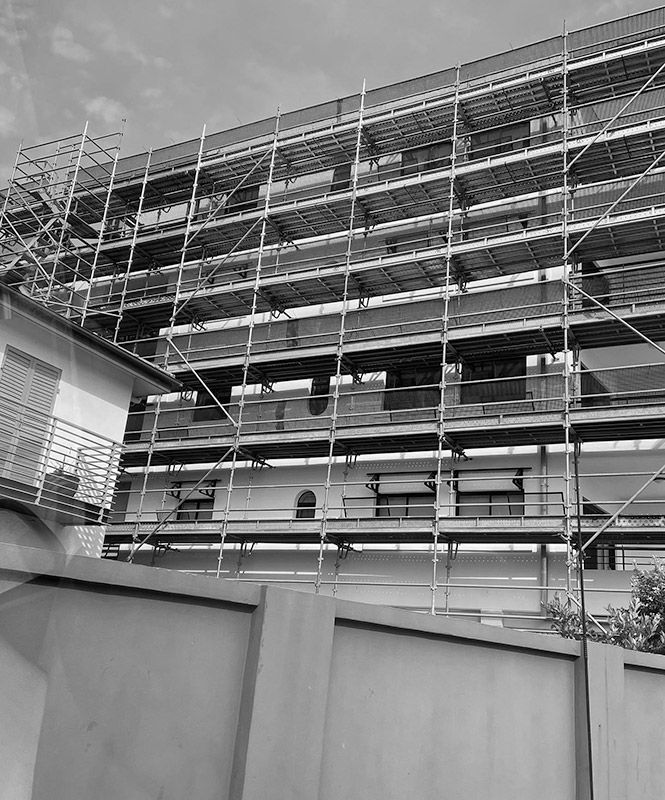 A Black and White Photo of a Building Under Construction With Scaffolding — RM Scaffolding Solutions in Lennox Head, NSW