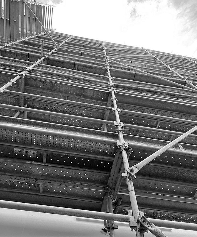 A Black and White Photo of a Building Under Construction With Scaffolding — RM Scaffolding Solutions in Northern Rivers, NSW