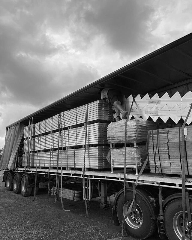 A Black and White Photo of a Truck Filled With Wooden Pallets — RM Scaffolding Solutions in Lennox Head, NSW