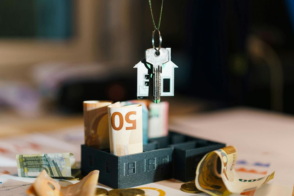 Handmade miniature money box with paper cash and coins on a table