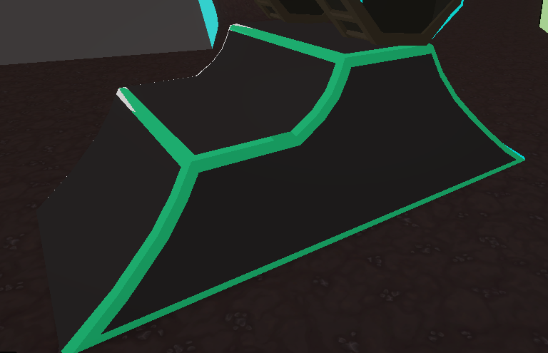 A black and green skateboard ramp is sitting on the ground.
