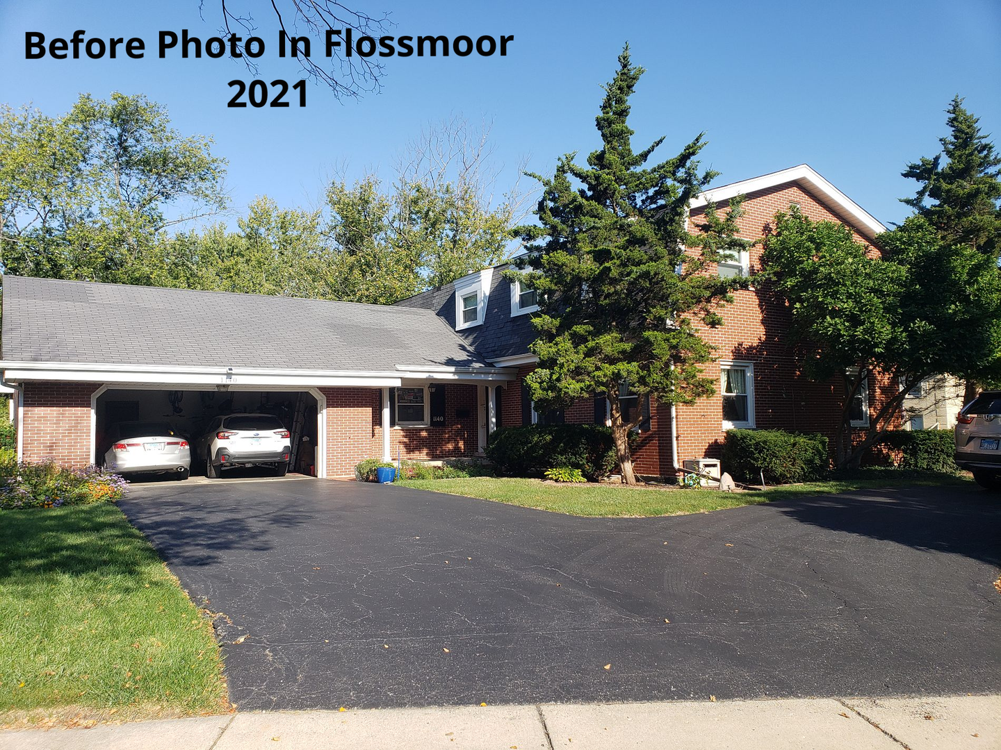 Two cars are parked in front of a brick house in flossmoor.
