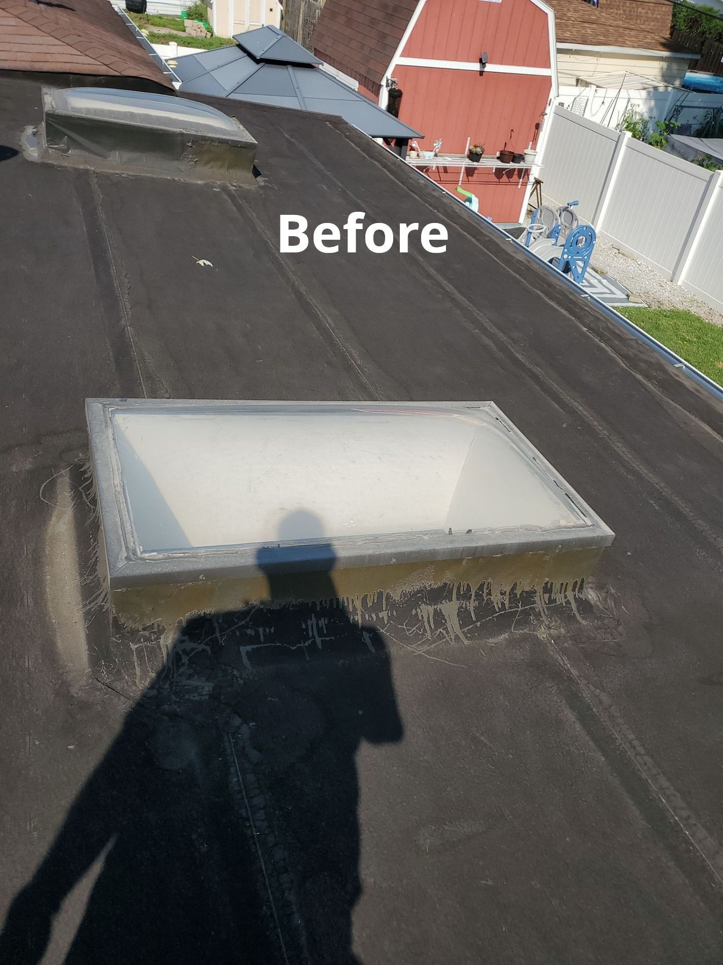 Two rectangular skylights set into a flat, dark-colored roof, marked with the label 