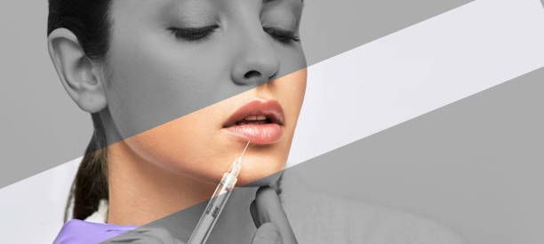 A woman is getting a botox injection in her lips.