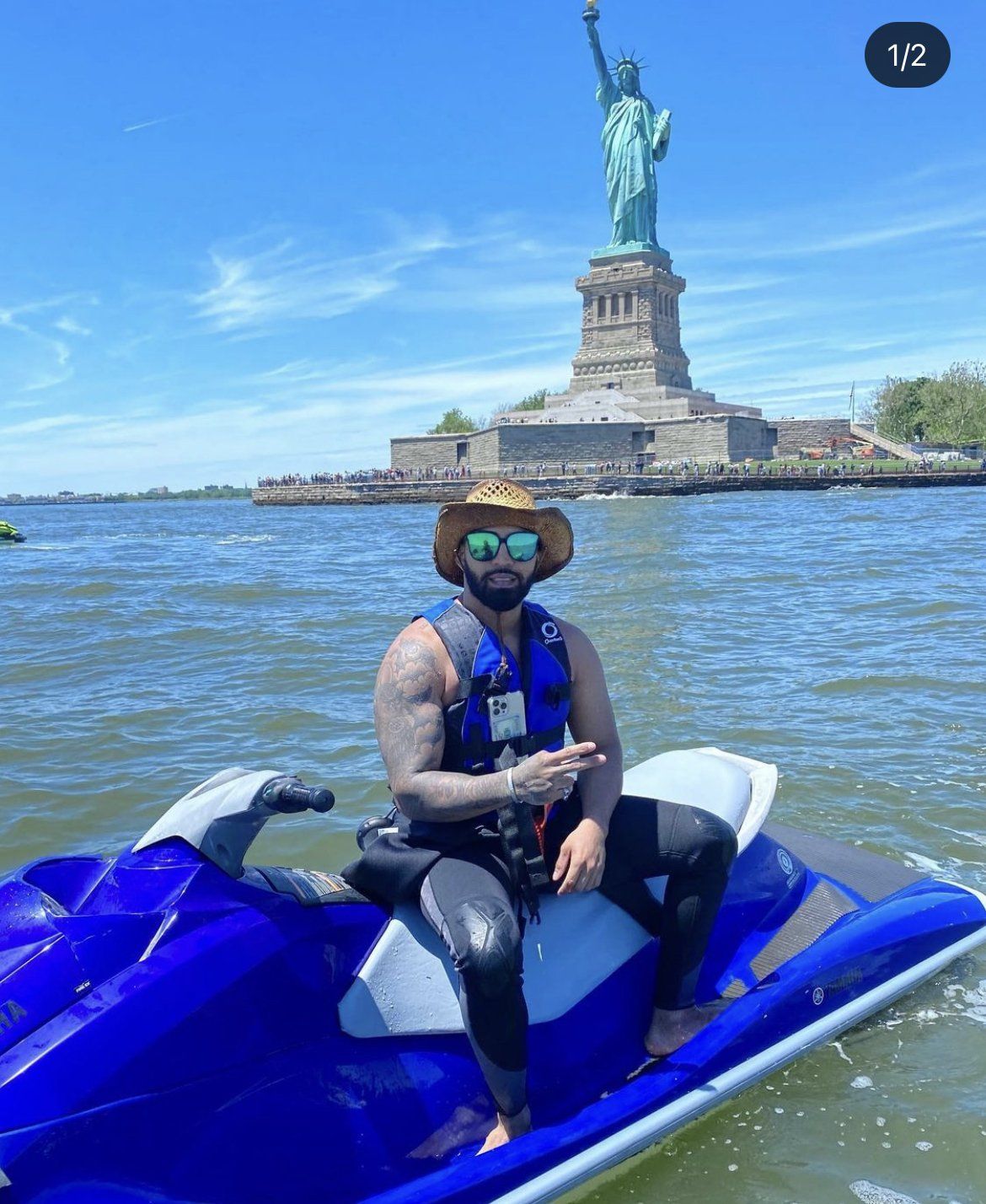 man sitting on blue jet ski