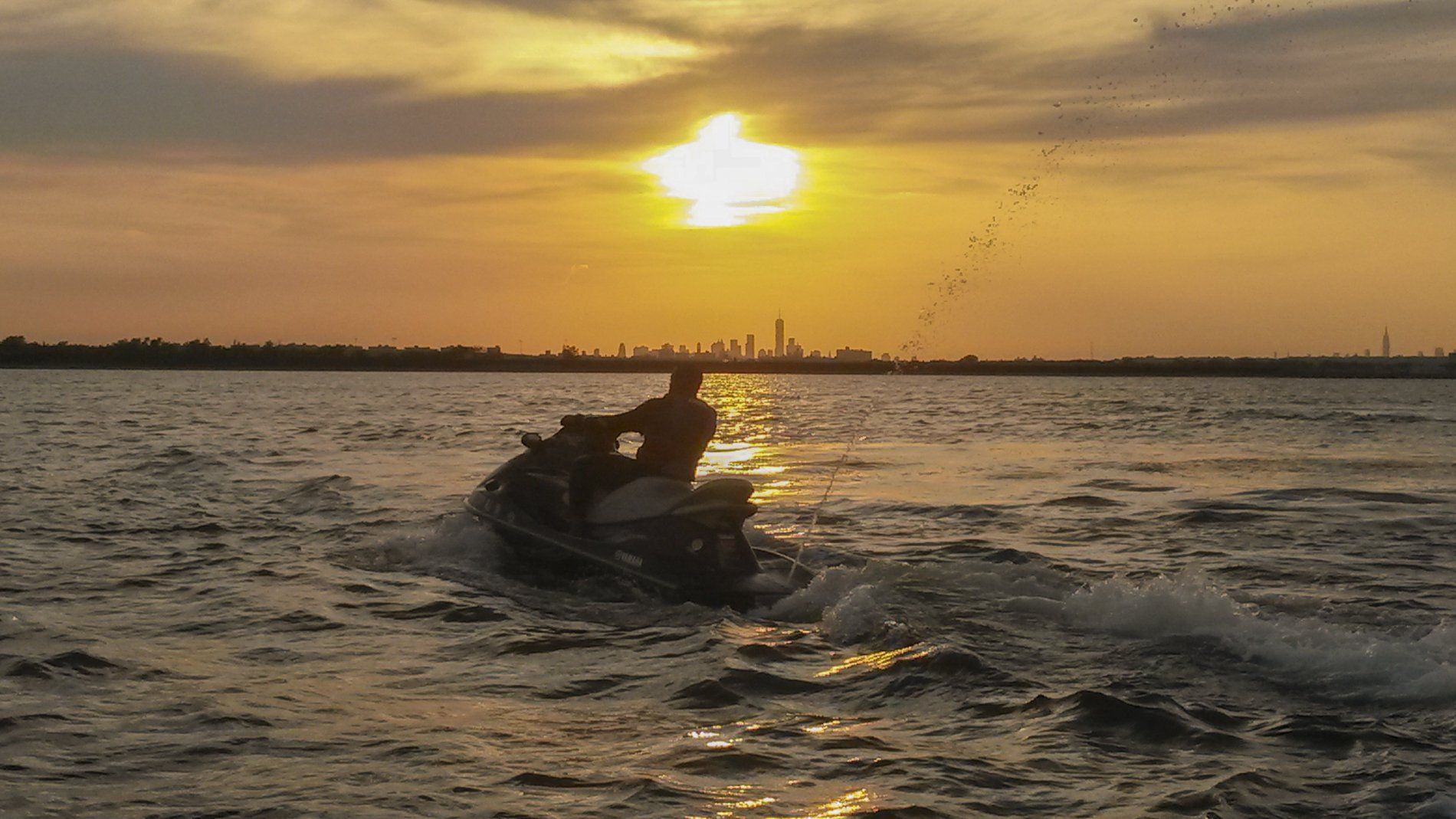 beautiful sunset and man riding on jet ski