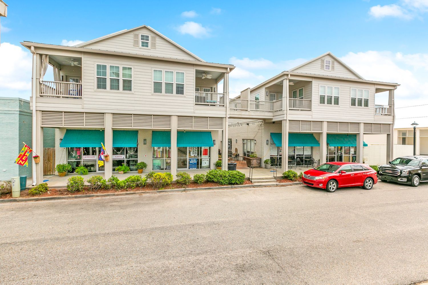 A couple of cars are parked in front of a building.