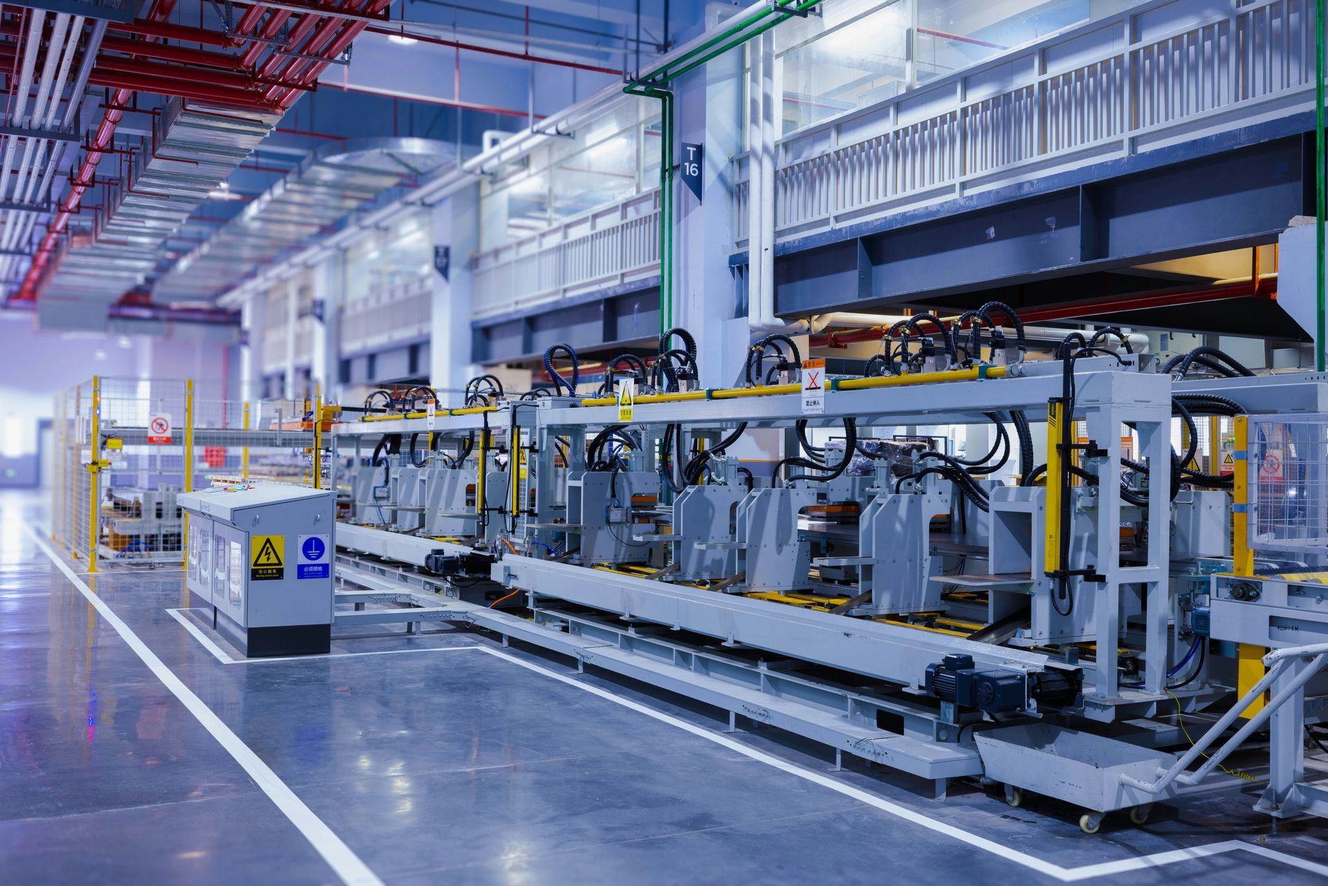 A factory with a lot of machinery and a conveyor belt.