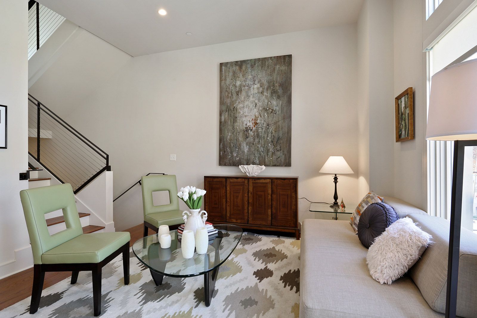 A living room with a couch and two chairs