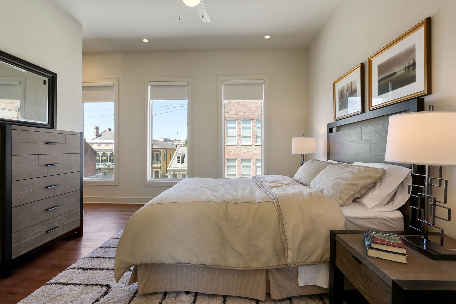 A bedroom with a large bed and a dresser