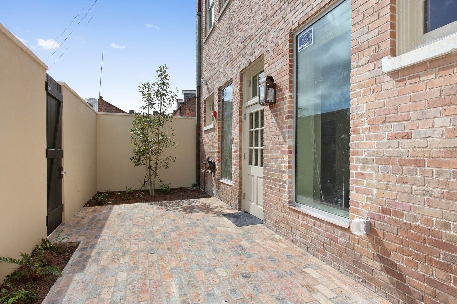A brick building with a patio in front of it.