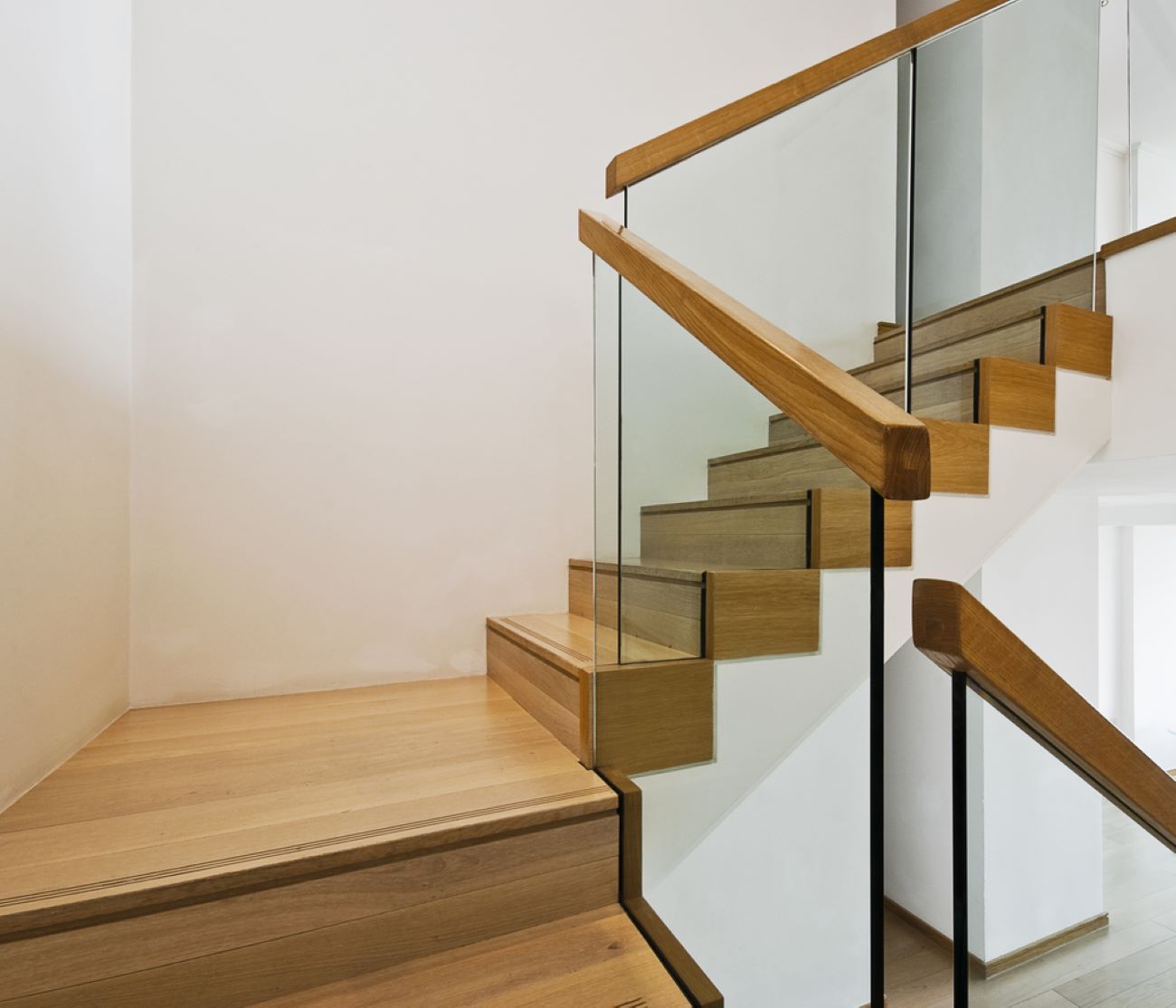 A Staircase With Wooden Steps and a Glass Railing — Top Shelf Glass Pool Fencing & Balustrading in Helensvale, QLD