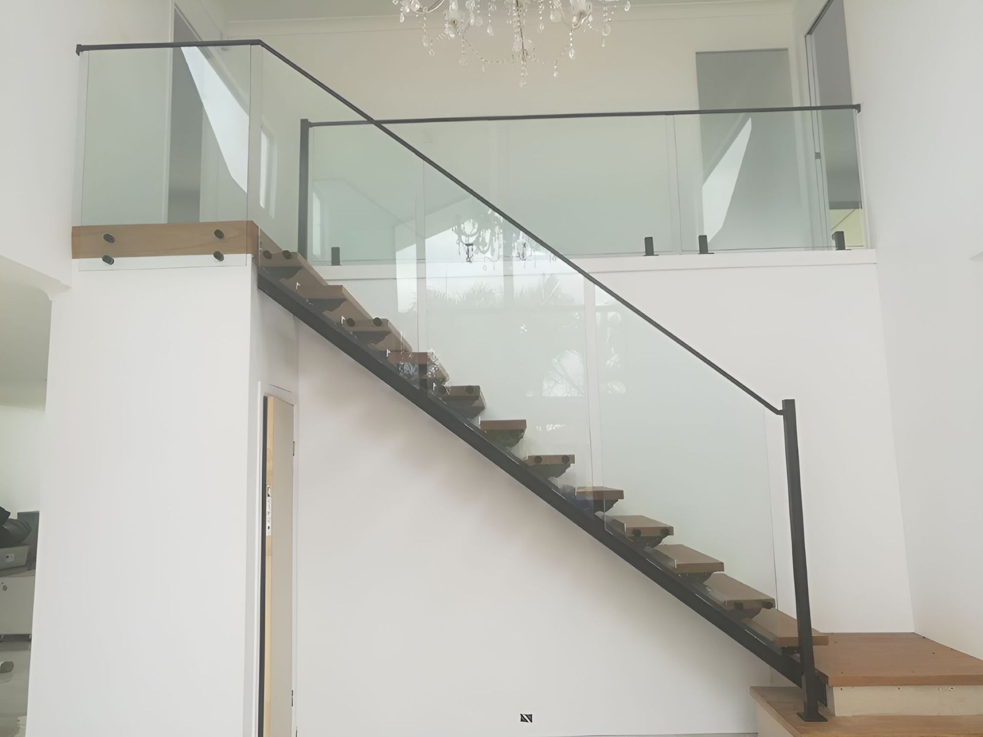 A Staircase With a Glass Railing and Wooden Steps in a House — Top Shelf Glass Pool Fencing & Balustrading in Merrimac, QLD