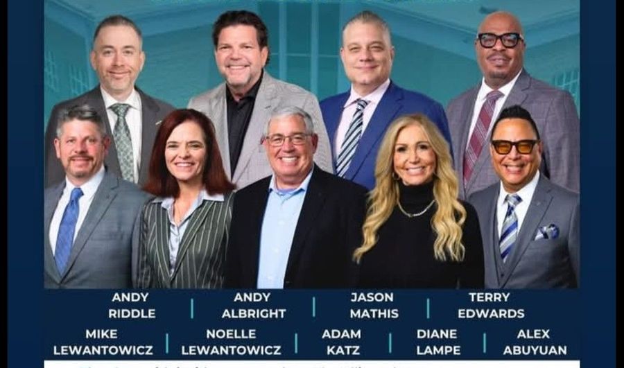 Seven-person professional group portrait with names labeled beneath each person.