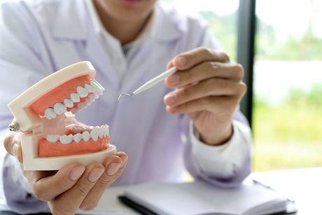 Dentist work on the table with Denture and teeth x-ray