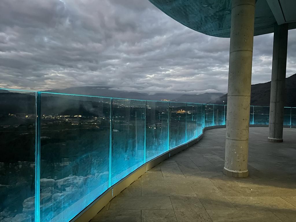 balcone con ringhiera in vetro illuminata di blu
