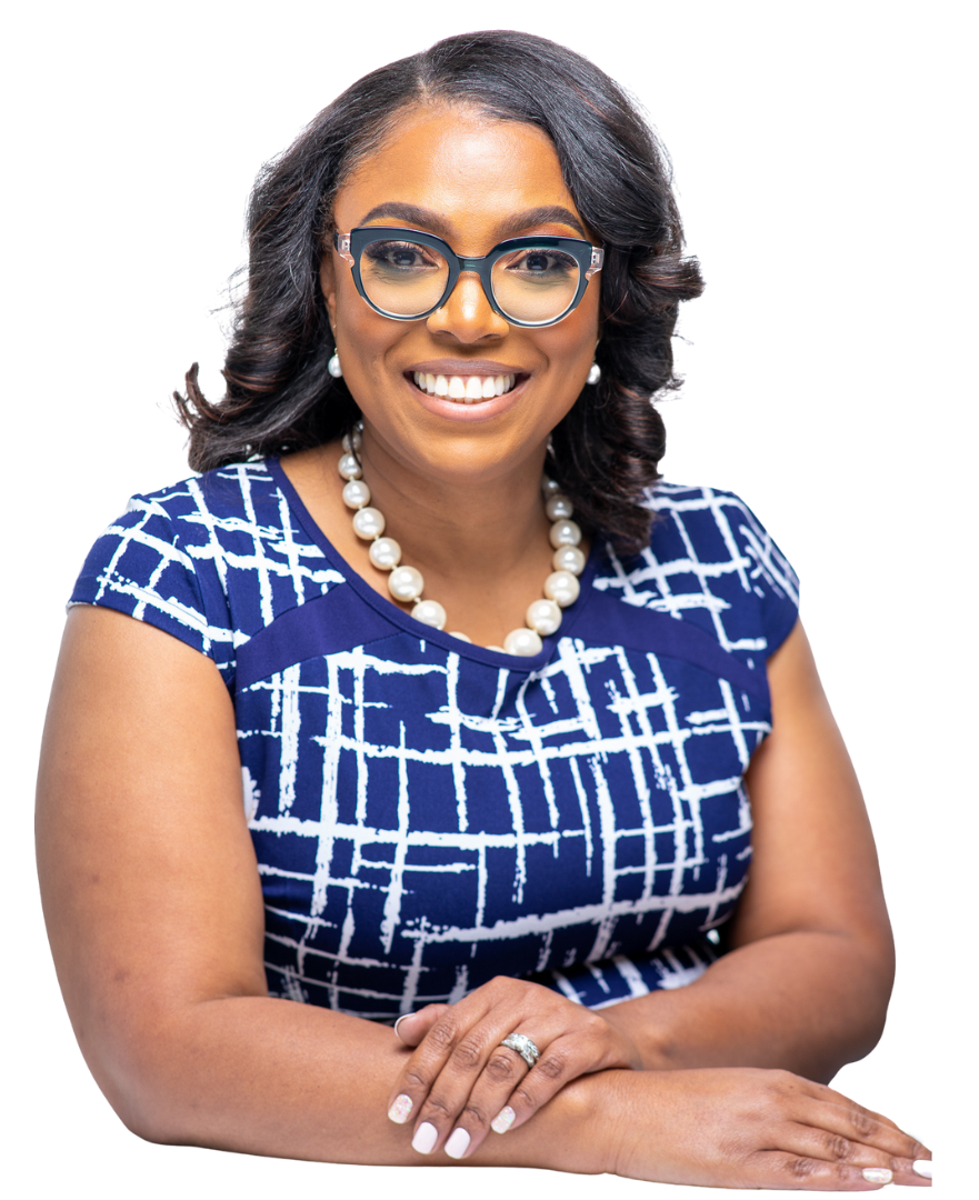 Nicola Robinson wearing glasses and a blue shirt is smiling.