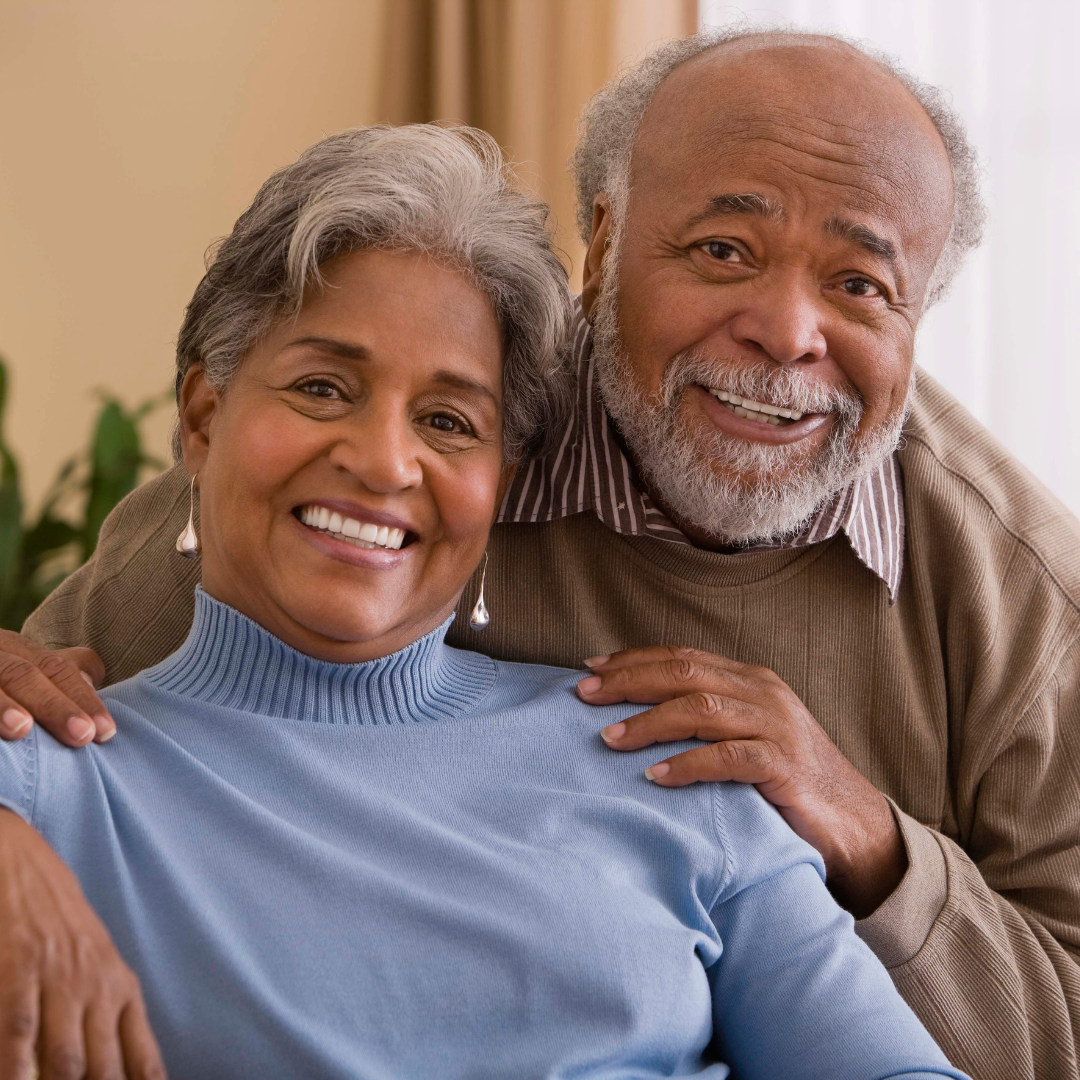 A man and woman are posing for a picture and smiling for the camera.