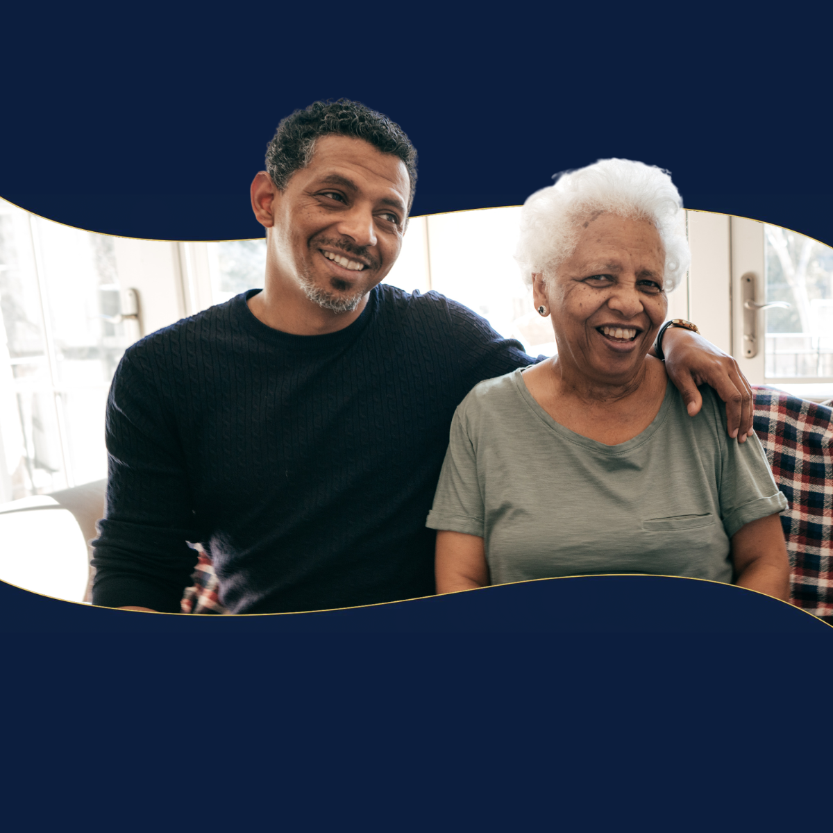A man and an older woman are sitting next to each other on a couch.