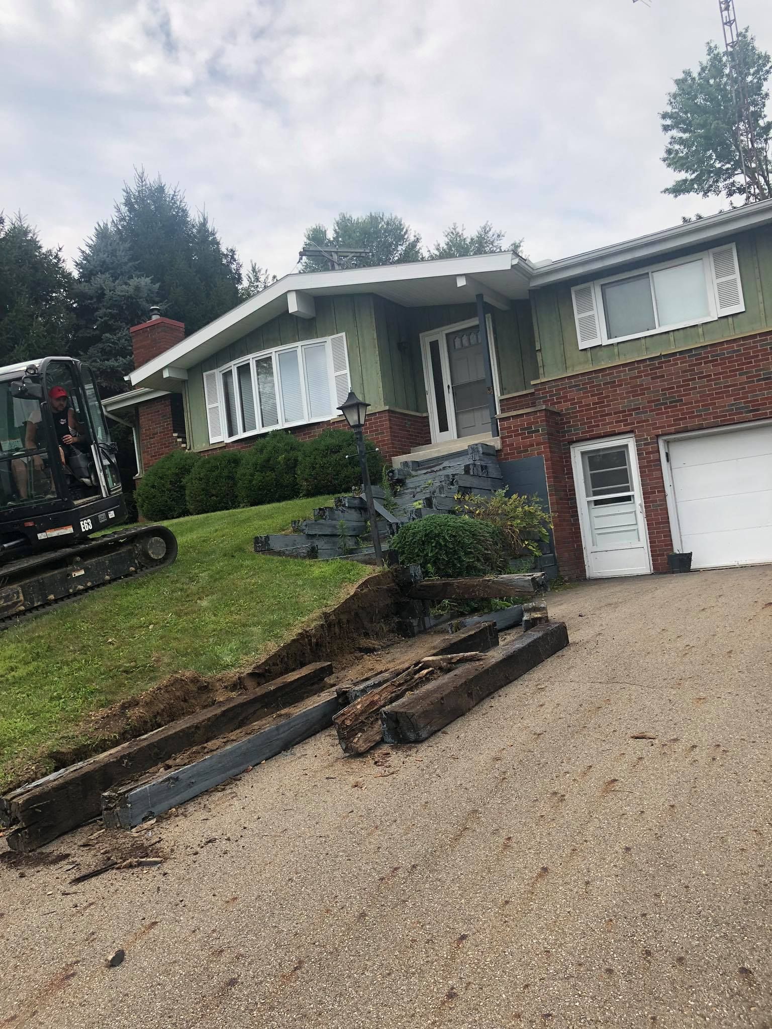 A house with a tractor parked in front of it.