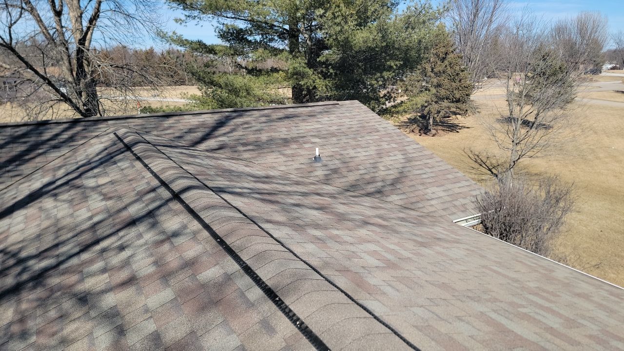 An aerial view of a roof with trees in the background.