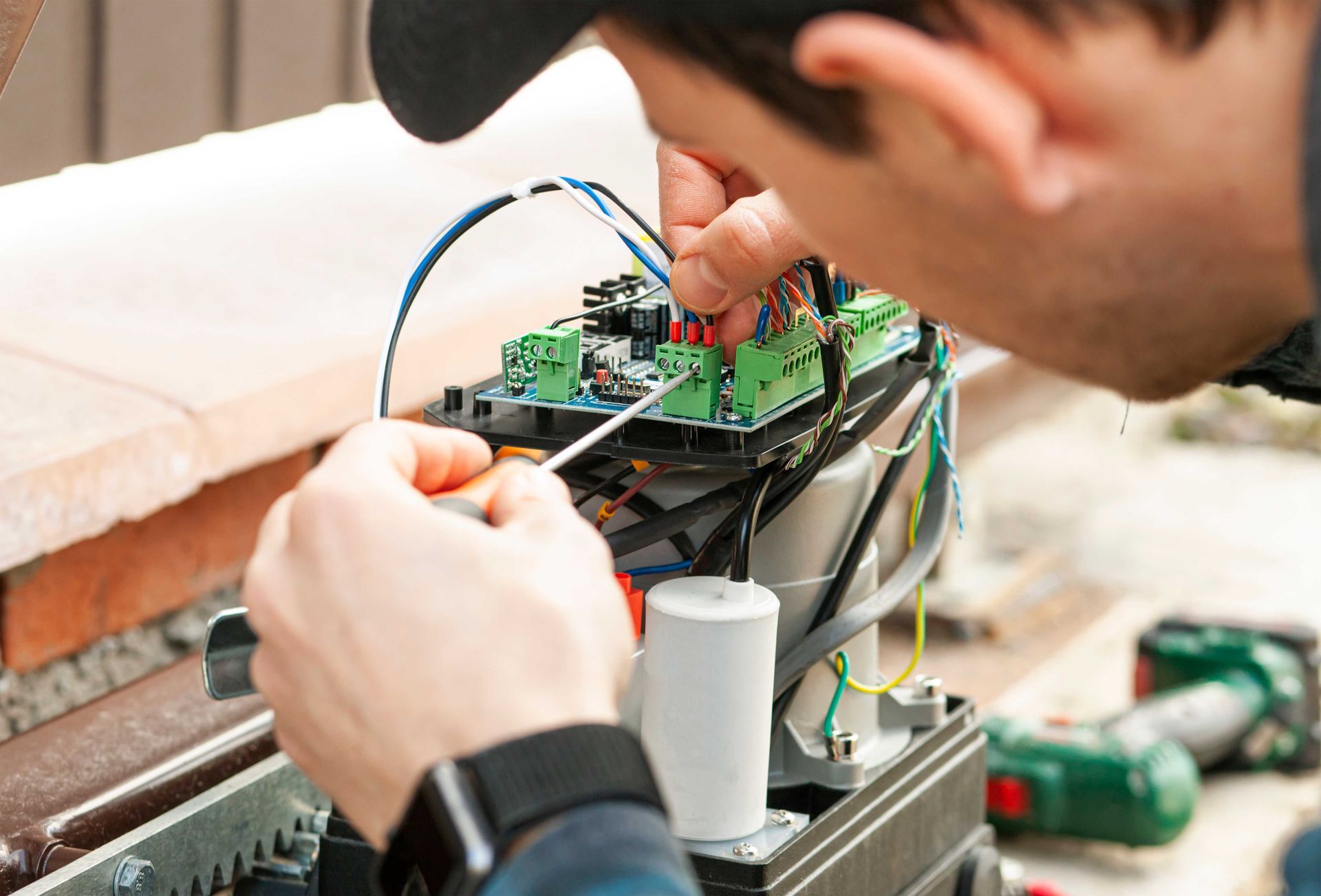 a man is working on a machine with a screwdriver .
