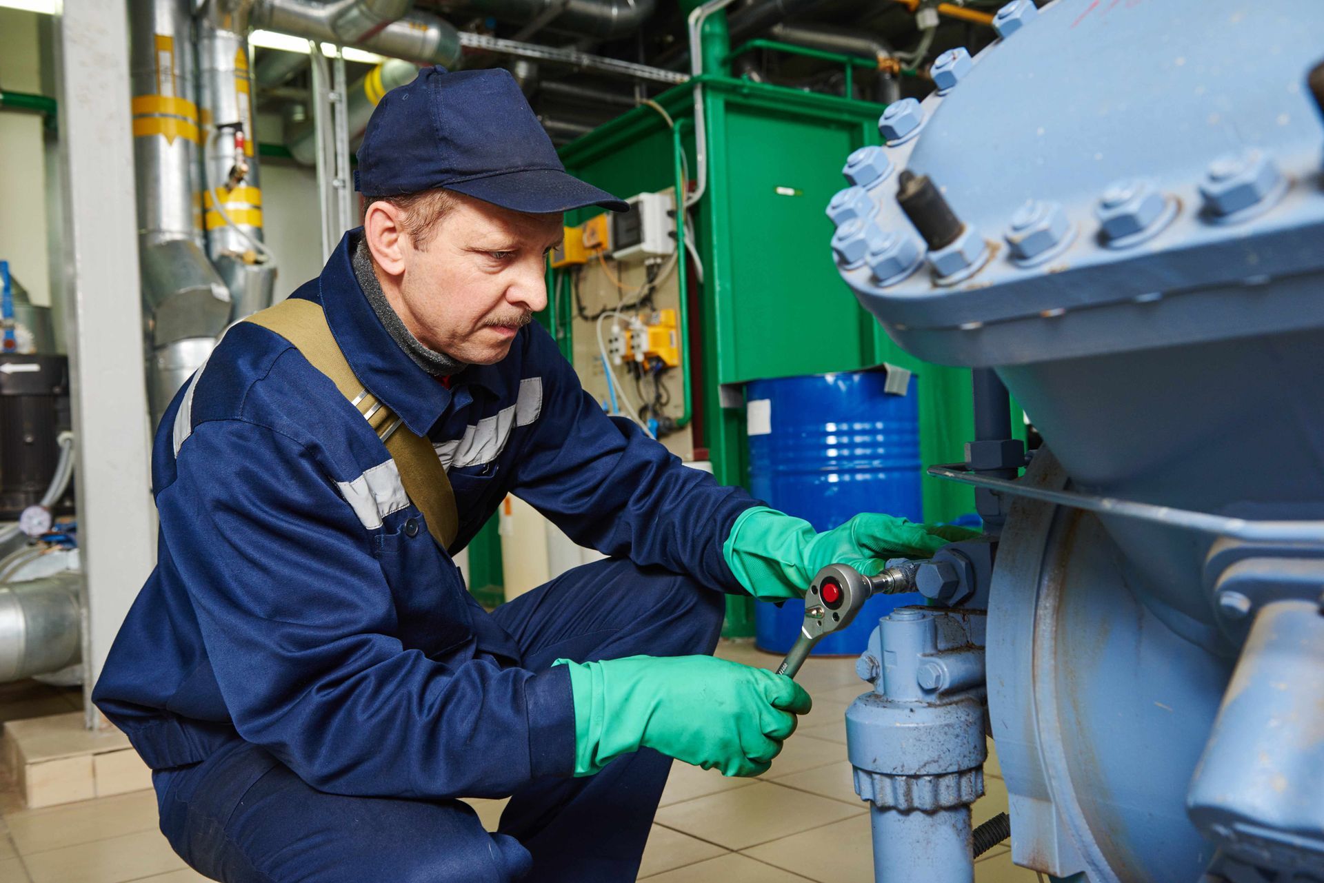 a man is working on a machine in a factory .