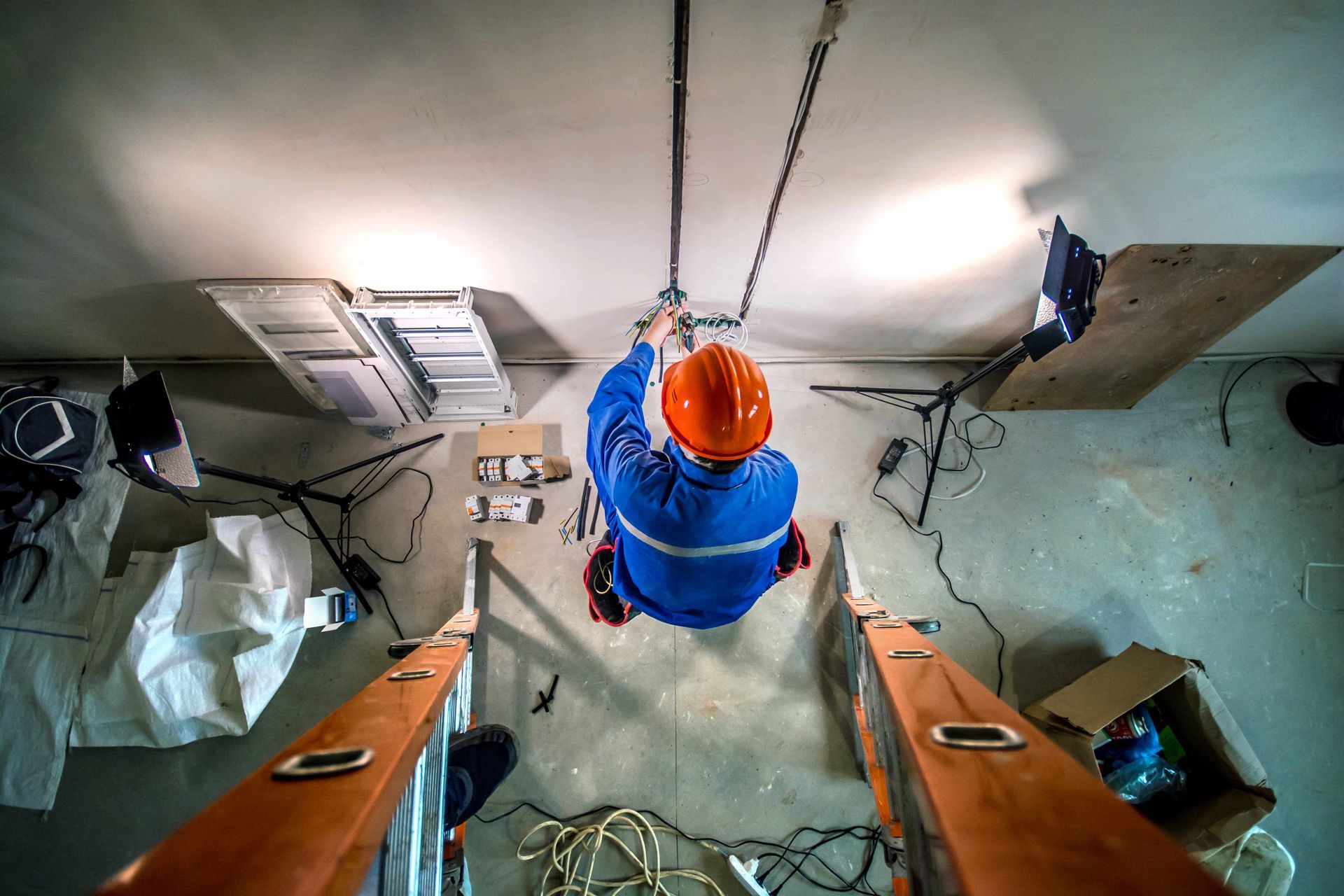 a man in a hard hat doing rewiring