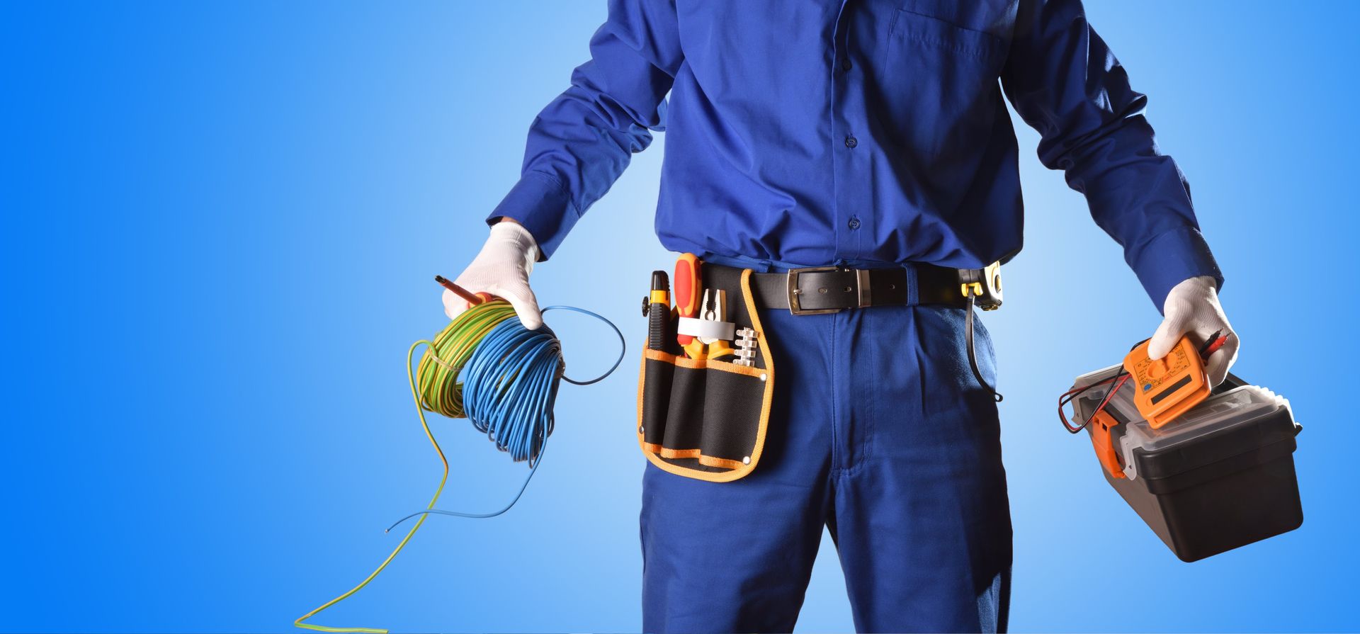a man in blue overalls is holding a toolbox and a measuring tape .