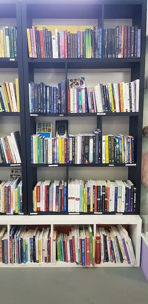 A Bookshelf Filled with Lots of Books — Crystal Cauldron in South Mackay, QLD