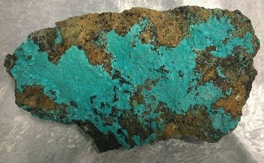 A Piece of Turquoise Rock Adorned with Splashes of Brown and Green Paint — Crystal Cauldron In South Mackay, QLD