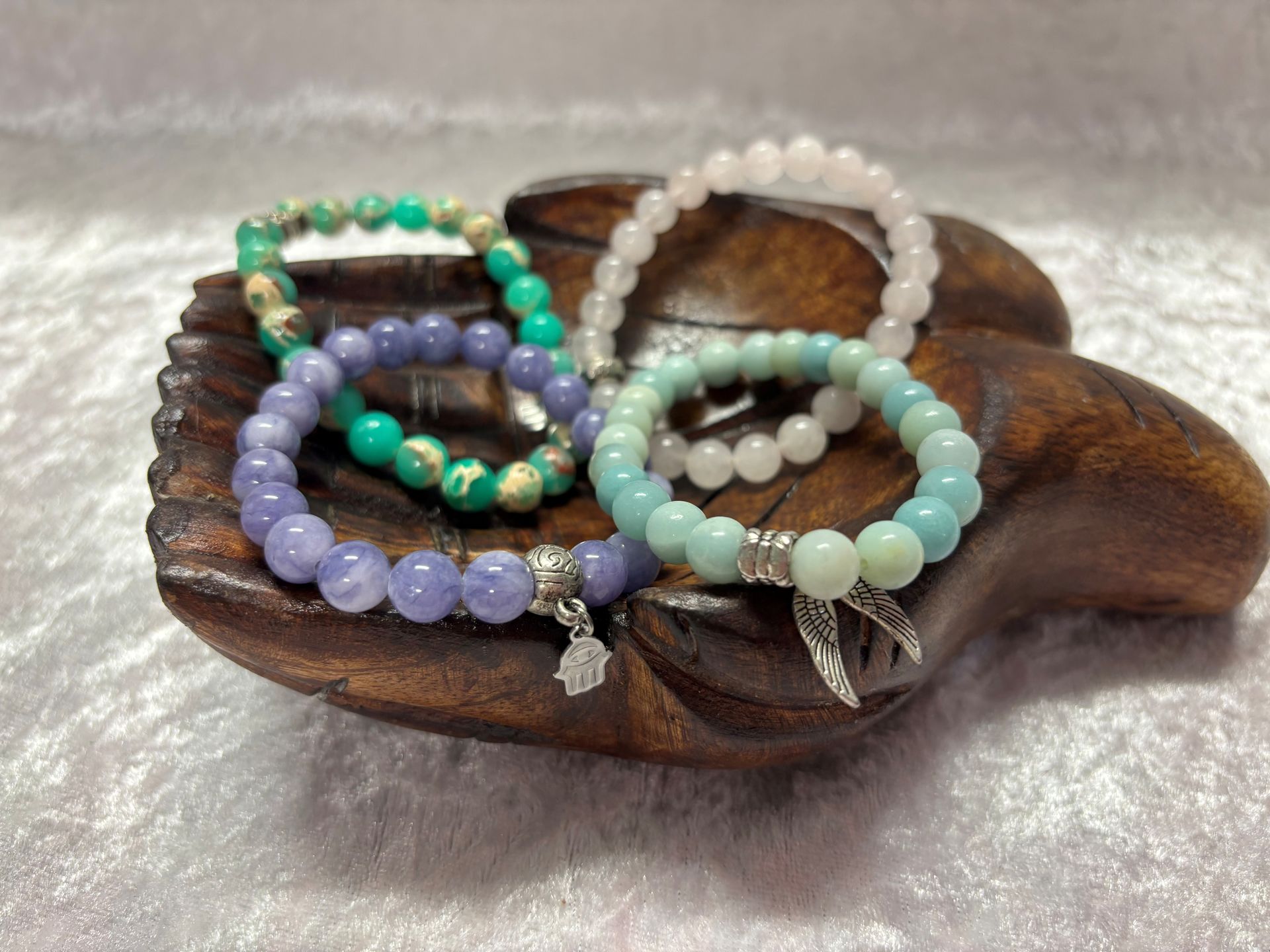 A Bunch of Bracelets Are on A Wooden Display — Crystal Cauldron in South Mackay, QLD