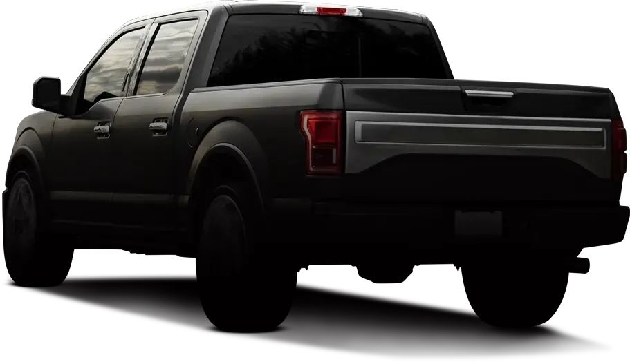 Back view of black truck in shadow | Krystal Automotive