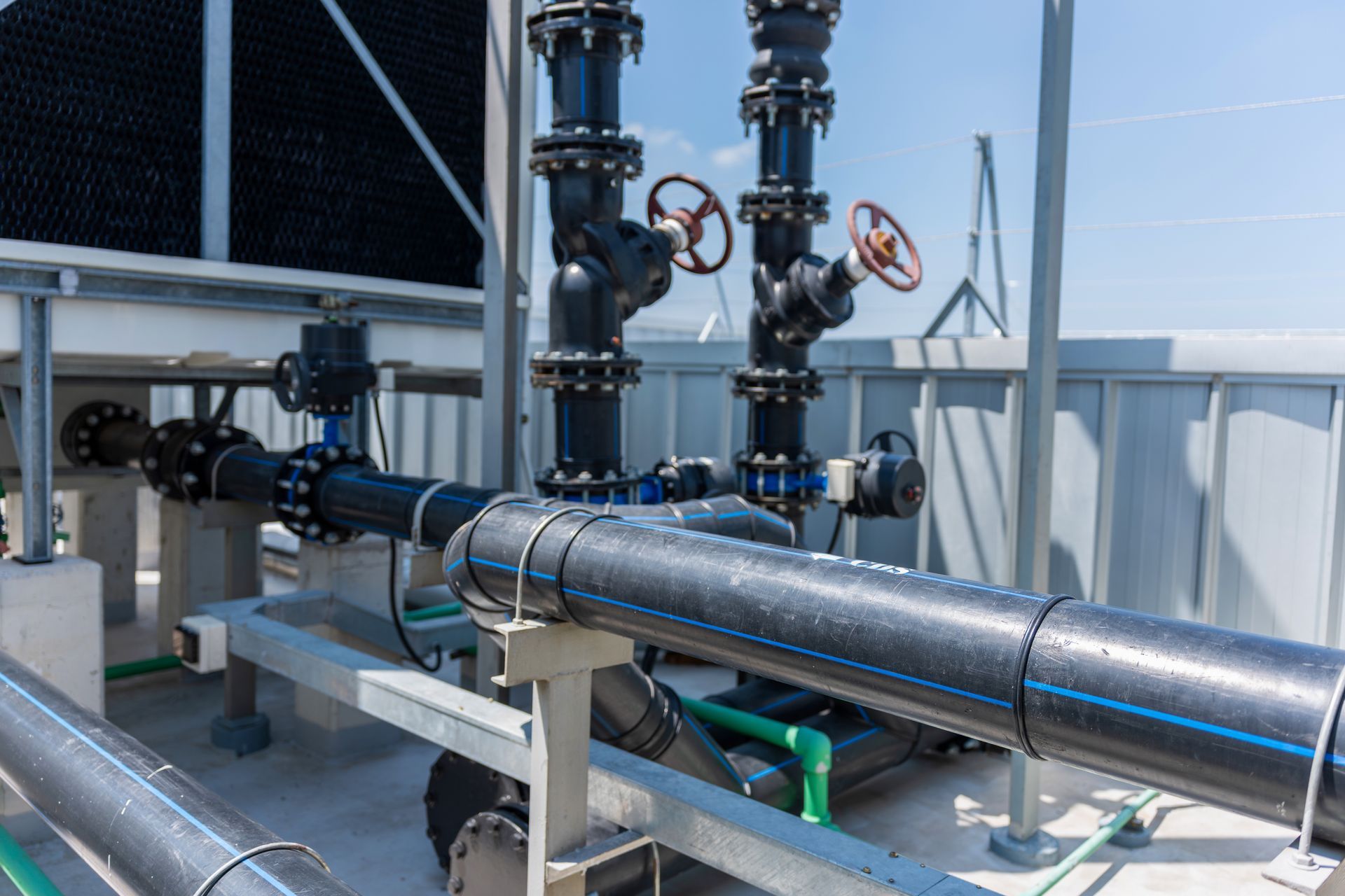 Industrial cooling tower pipe system and valves infrastructure on rooftop