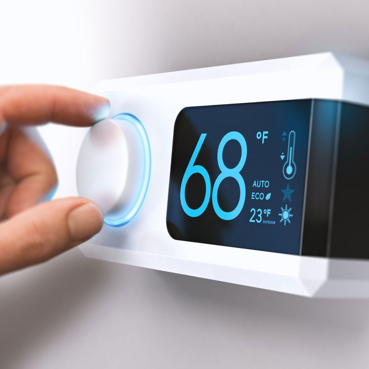 A person is adjusting a thermostat to 68 degrees A person is adjusting a thermostat to 68 degrees
