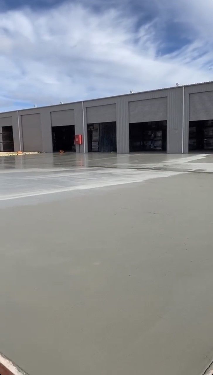 Construction Workers Leveling Concrete Pavement — Commercial Concreting in Inverell