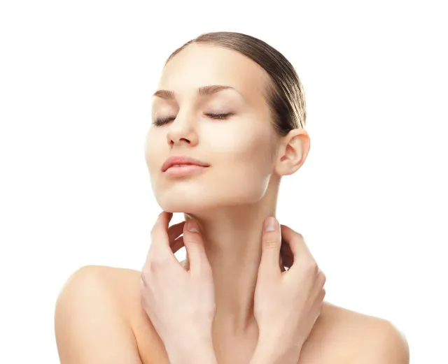 Woman with closed eyes gently touching her neck against a white background