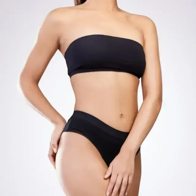 Black strapless bandeau bikini on a person against a white background