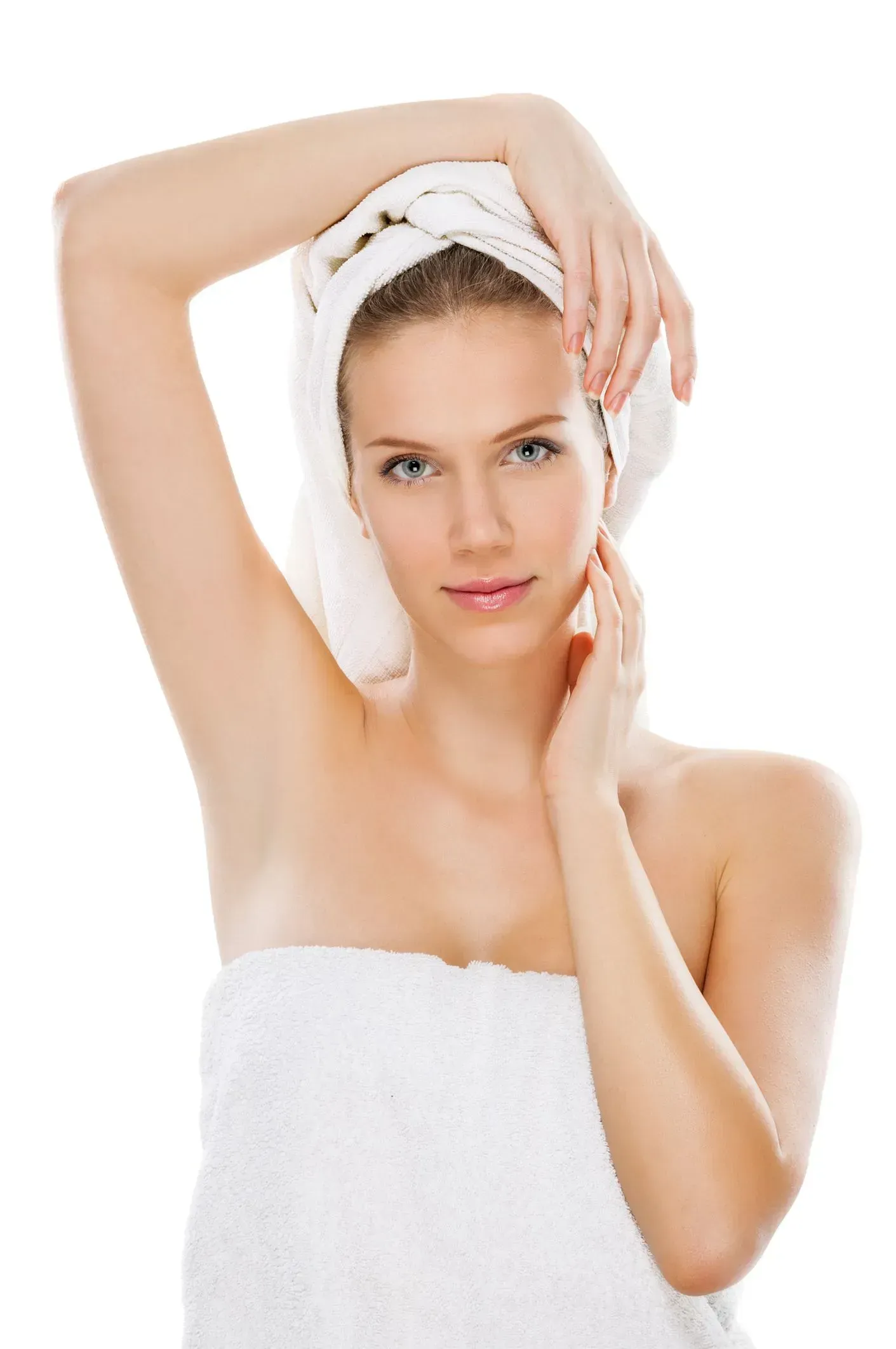 Woman wrapped in a white towel and headband posing with arms raised against a white background
