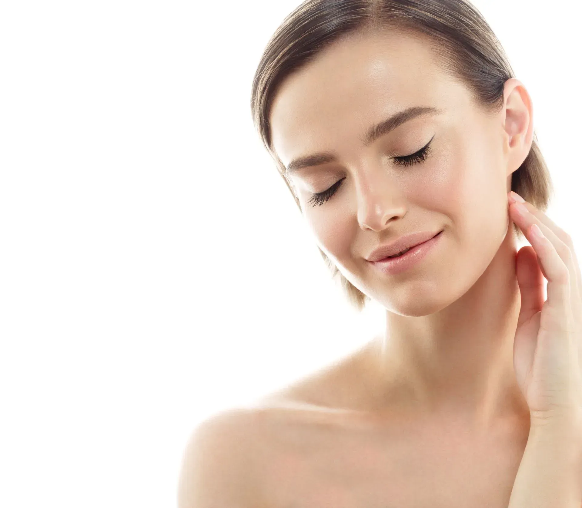 Close-up of a woman with eyes closed, gently touching her neck against a bright white background