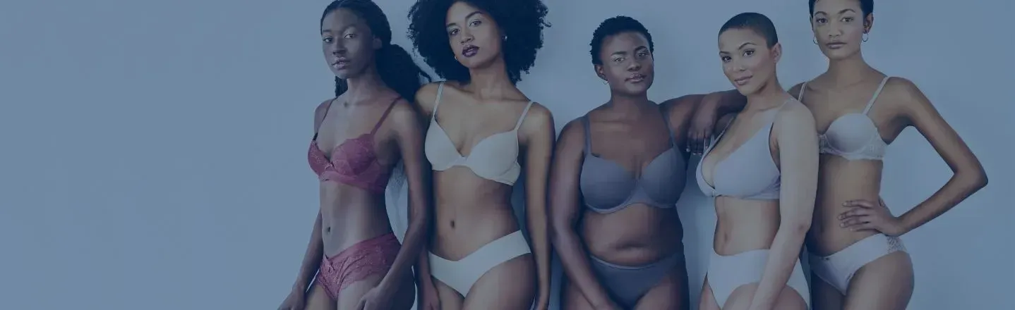 Five women pose side by side in colorful lingerie against a plain light background.