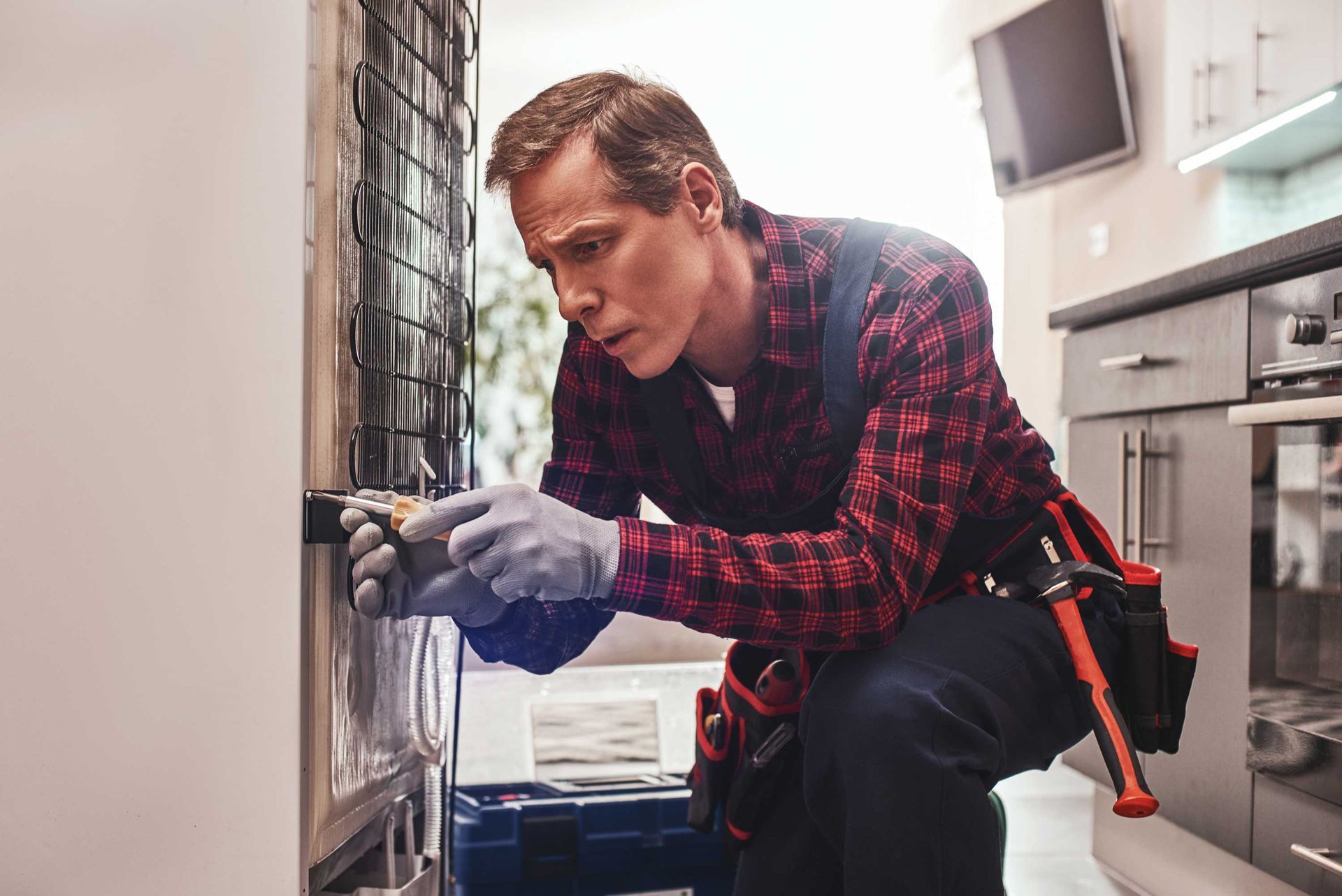 Senior male technician checking refrigerator. Senior male technician checking refrigerator.