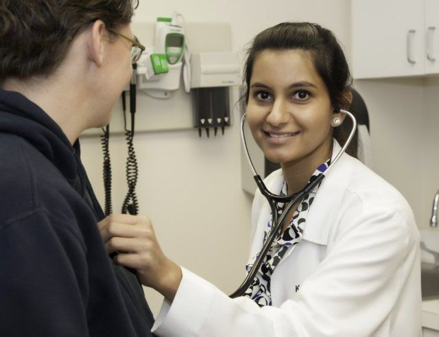 A female doctor examines a patient with a stethoscope A female doctor examines a patient with a stethoscope