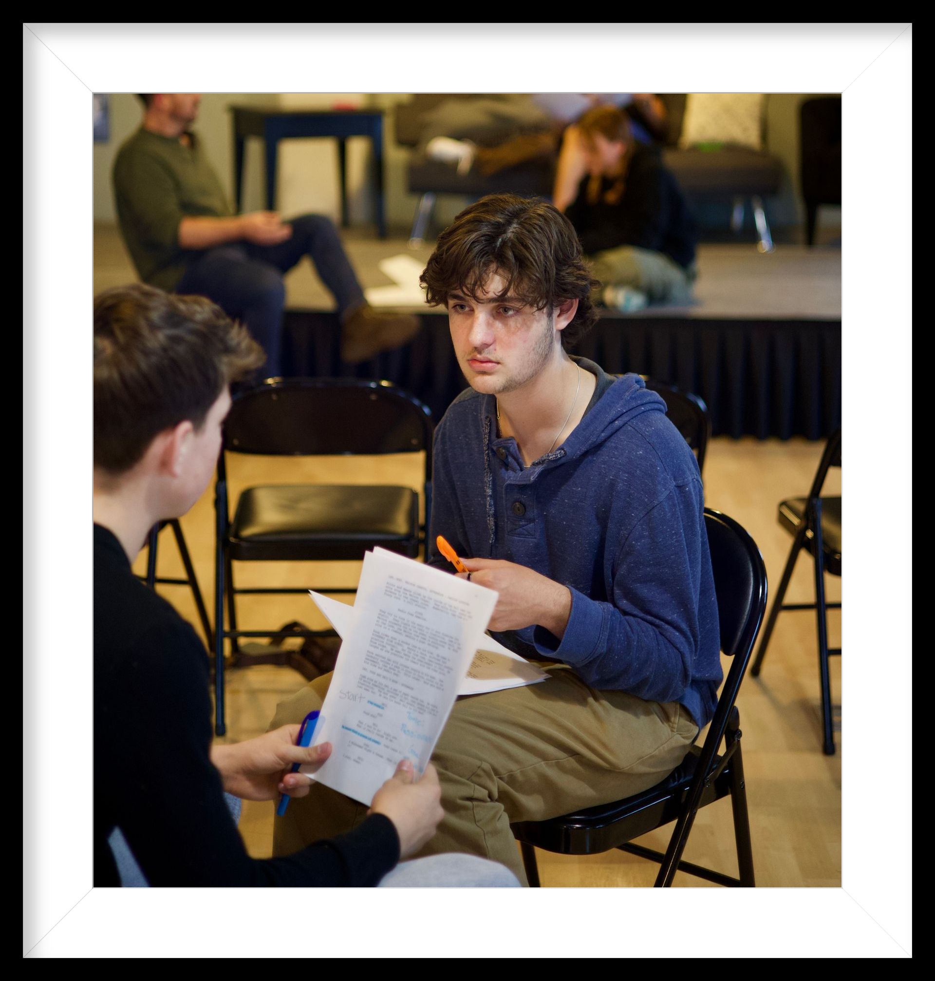 Film and television acting coach helping performer improve confidence and camera presence during training