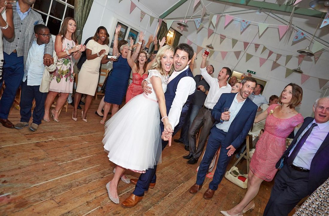 Happy guests dancing at an event with The RockPins.